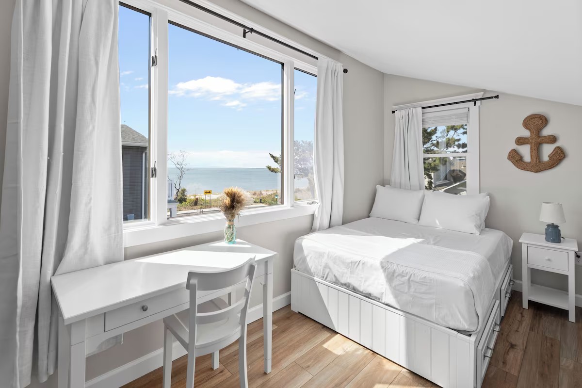 Guest bedroom with bay view and coastal decor