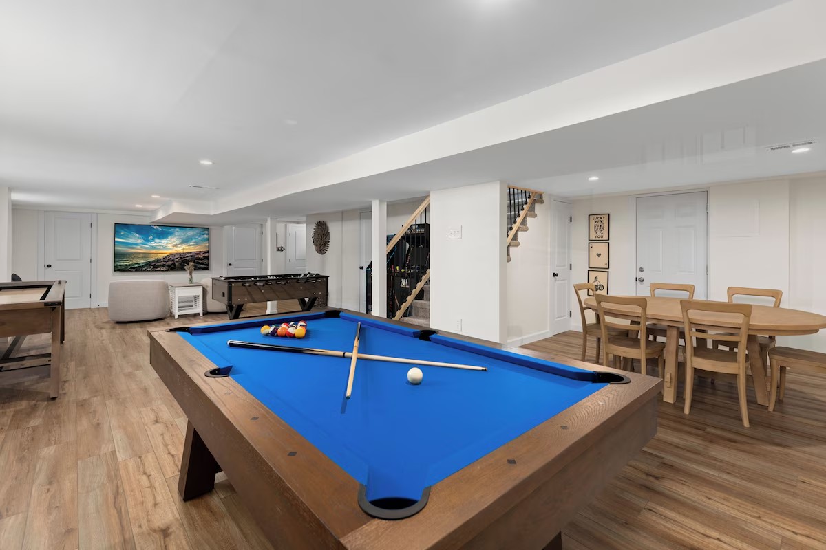 Lower-level game room with pool table and foosball